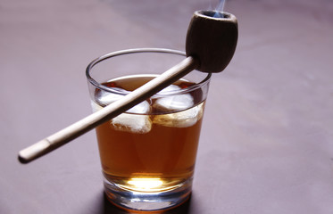 A glass of alcohol and a Smoking pipe