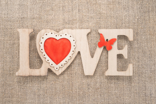 Love sign on a burlap background 