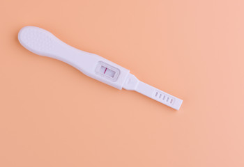 Pregnancy test with yellow background, health care concept.