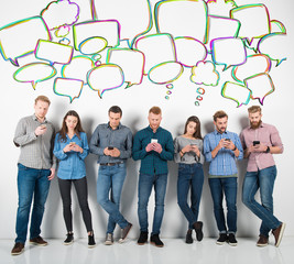 Fototapeta premium Group of boys and girls connected with their smartphones. Concept of internet and social network