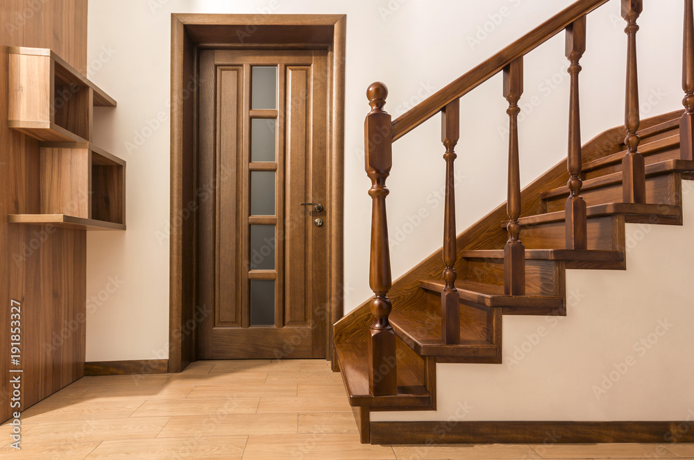 Poster Modern brown oak wooden stairs  and doors in new renovated house interior