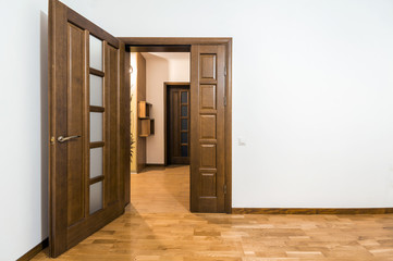 Fototapeta premium New brown wooden door in house interior