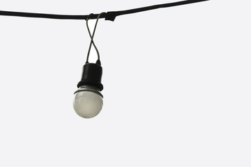 A classic light bulb, hanging on wire in the white background isolated