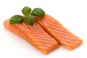 Fresh salmon fillet with basil on the white background.