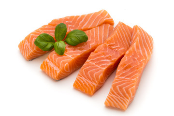Fresh salmon fillet with basil on the white background.