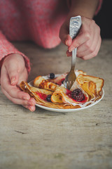 Pancakes (crepes) with berries and sweet jam