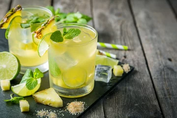 Tuinposter Pineapple and lime drink on rustic background © anaumenko
