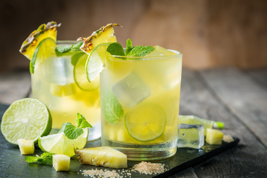 Pineapple and lime drink on rustic background