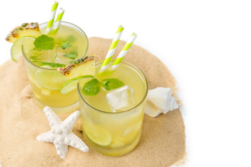 Pineapple and lime drink on rustic background