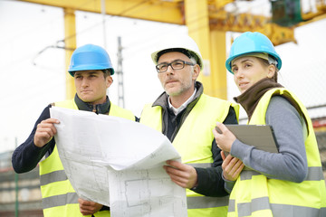 Construction site manager with young people in training period