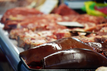 Pieces of fresh beef lying on the counter on the market.
