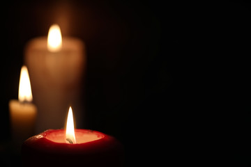 Burning candle flame in the dark