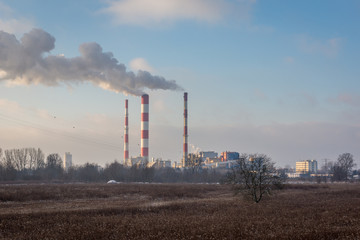 Fototapeta na wymiar Smoking chimneys from the Siekierki power plant in Warsaw, Poland