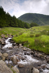 A picturesque mountain stream feeding into the head of Haweswater reservoir in Mardale valley, Cumbria, UK