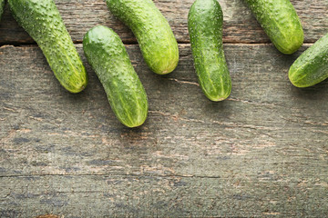 Fresh cucumbers on grey wooden table