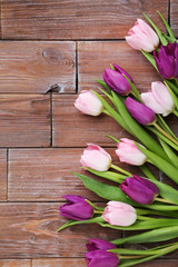 Bouquet of tulips on a brown wooden table