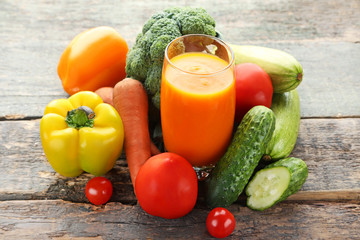 Vegetables smoothie in glasses on grey wooden table