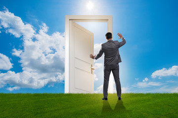 Fototapeta premium Businessman standing in front of door into future
