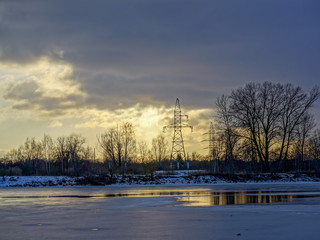 Fototapeta na wymiar colorful winter sunset on frozen river ice