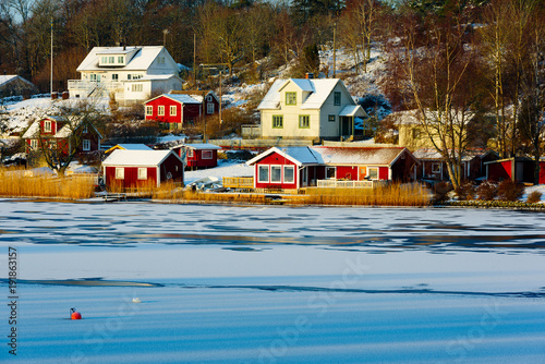 Small Seaside Village In Winter Landscape Bay Is Frozen And The Morning Sunshine Barely