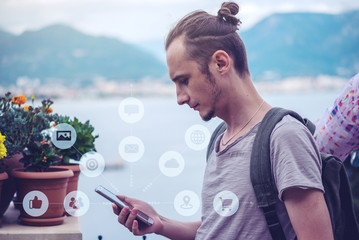 Man uses a smartphone to access social digital media in the Internet. Concept of a global network expansion