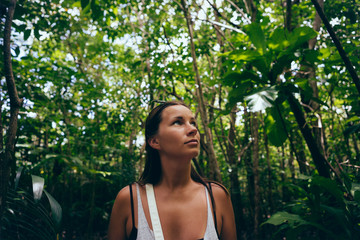 Travel lifestyle. Woman traveler in dense tropical forest