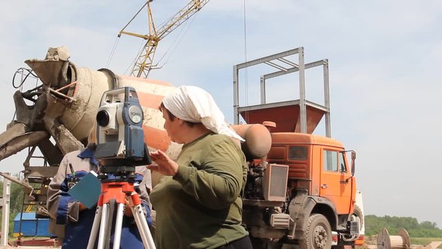 mine surveyors work on the construction of a coal mine\a woman works with the device