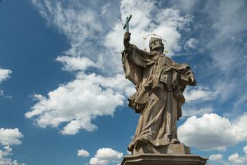 Fototapeta na wymiar Medieval statue of a saint on the old Main bridge