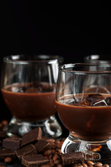 glasses of cream coffee cocktail or chocolate martini on black background