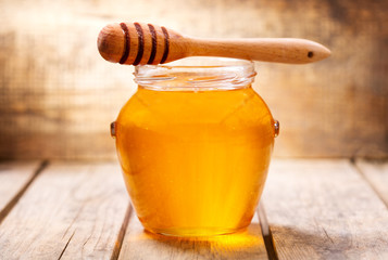jar of honey on wooden table