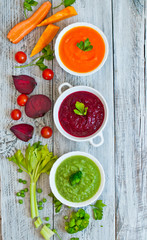 Variety of colorful vegetables cream soups and ingredients for soup. Top view. concept of vegetarian food
