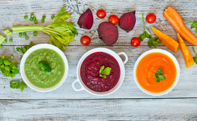 Variety of colorful vegetables cream soups and ingredients for soup. Top view. concept of vegetarian food