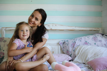 Family reading bedtime. Pretty young mother reading a book to daughter.