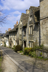 Fototapeta na wymiar Quaint Cotswold cottages in early spring sunshine on The Hill, Burford, Oxfordshire, UK