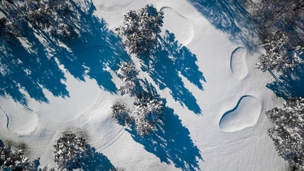 Drone view of a golf course covered by snow