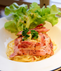 spaghetti carbonara sauce and bacon.