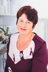 adult woman portrait. Christmas Studio . grandma decorates the Christmas tree