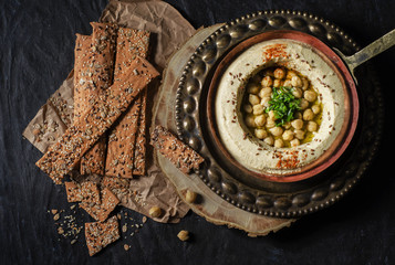 Delicious homemade Hummus salad served with wholegrain roasted bread.Close up,Top view 