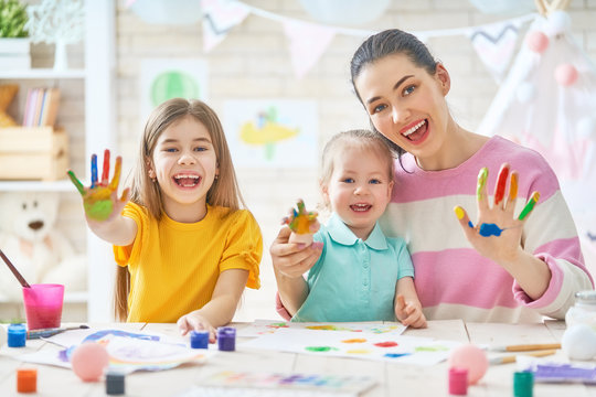 Mother and daughters painting together