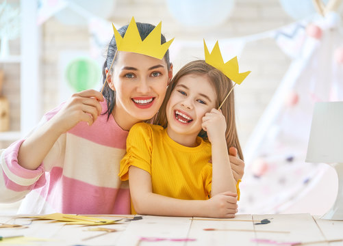 Mother and daughter with paper crowns