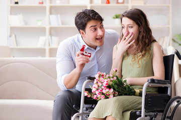 Man making marriage proposal to disabled woman on wheelchair