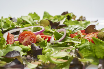 vegetables, salad and seeds on light wooden background