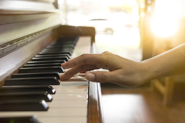 Close-up of a music performer's hand playing the piano