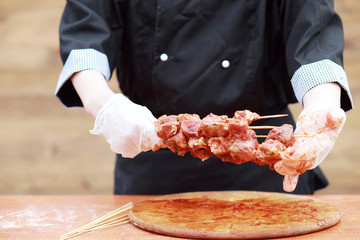 The cook cuts meat for cooking barbecue