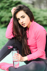 a young girl goes in for sports in the fresh air . Sports clothing pink color