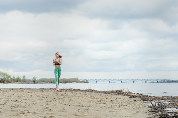 a young girl goes in for sports in the fresh air . Sports clothing pink color