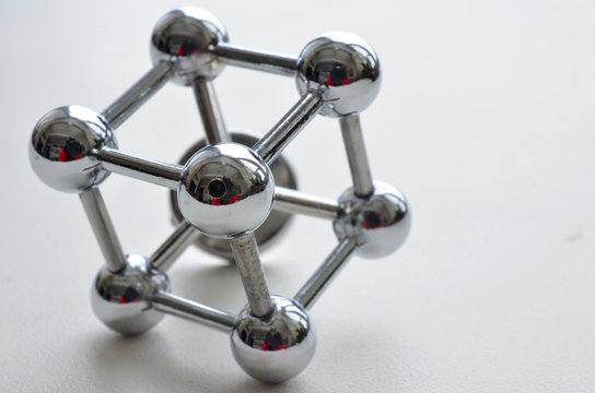 decorative image of an iron molecule made of stainless steel on a white background
