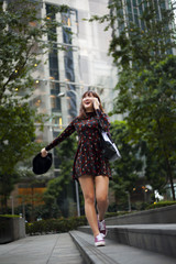 Shot of a young gorgeous woman walking through a garden in the city.