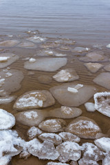 Fototapeta na wymiar Frozen ice crystals on the sea beach