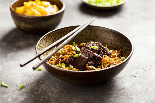 Asian noodle dish with beef and green onion